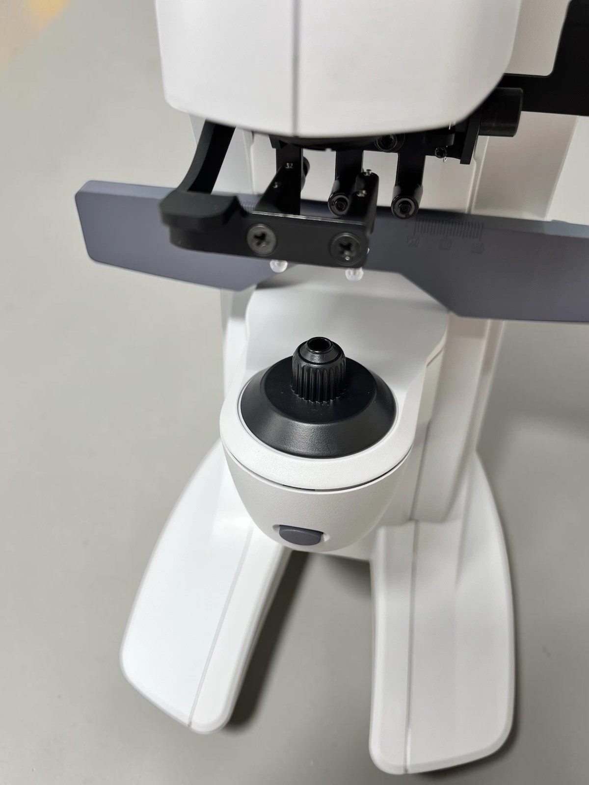 Nidek LM-7 - Auto Lensmeter - Used 5 Nidek LM-7 auto lensmeter used — close-up of lens holder marking pins and focus joystick